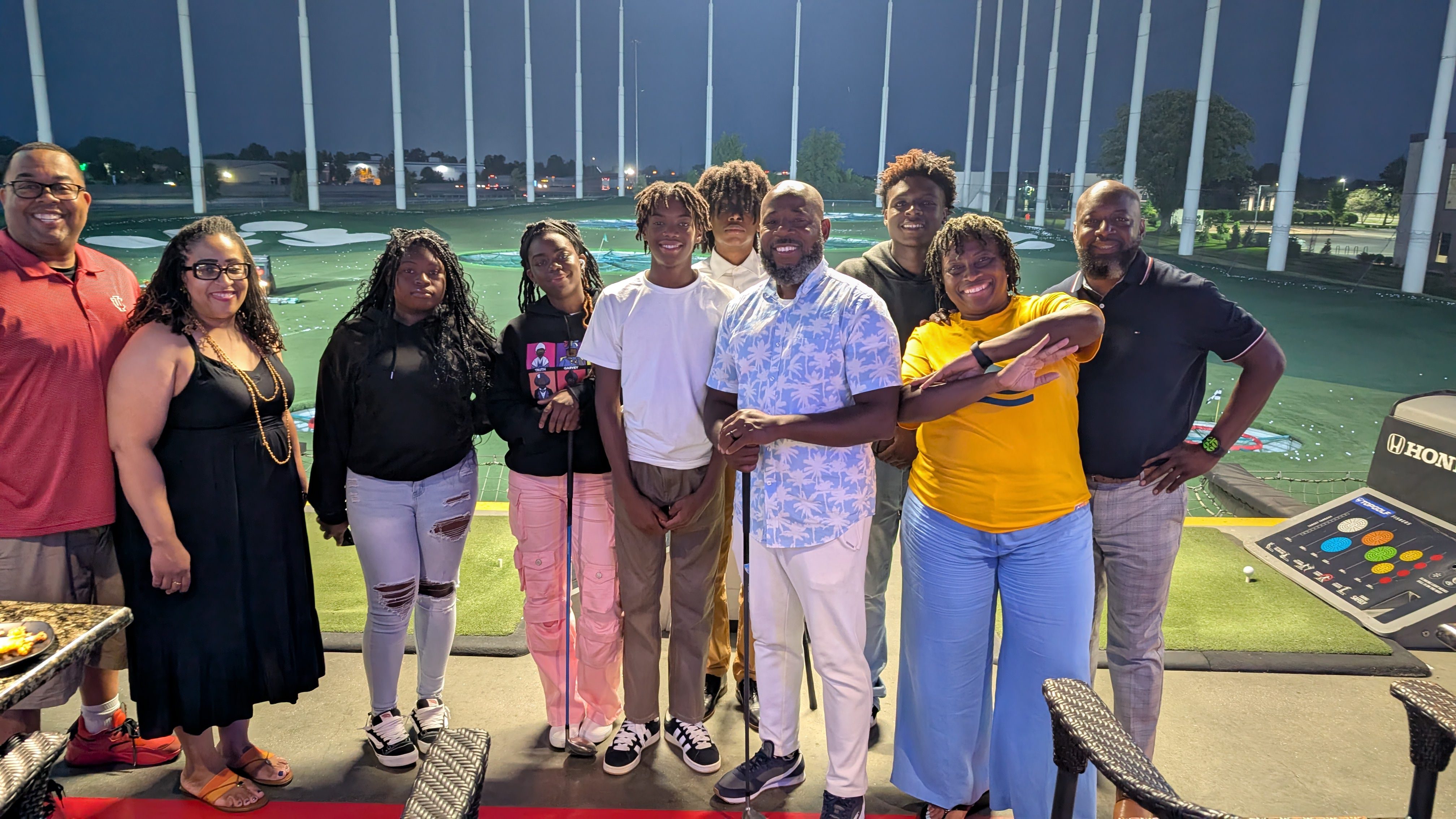 Group of people standing together outdoors in the evening