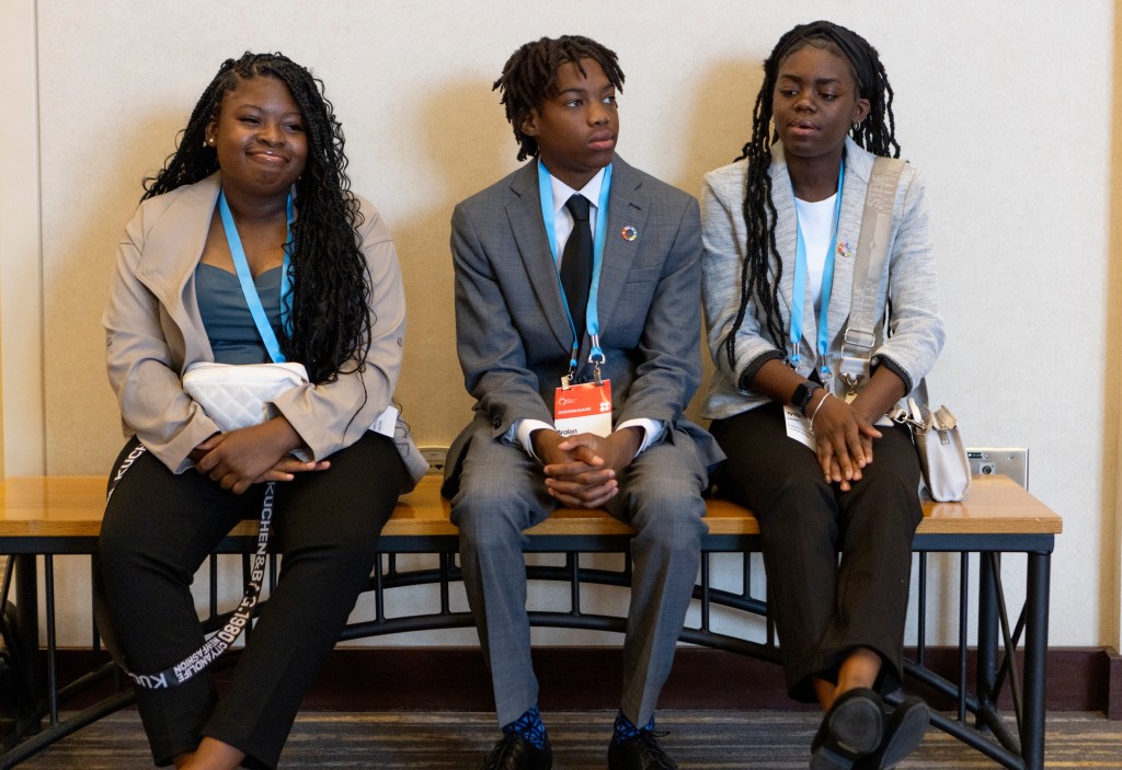 Youth and staff seated together during a Palatka Housing Authority program