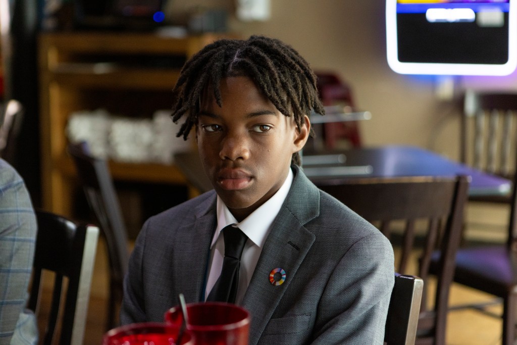 Young community member seated indoors during a Palatka Housing Authority event