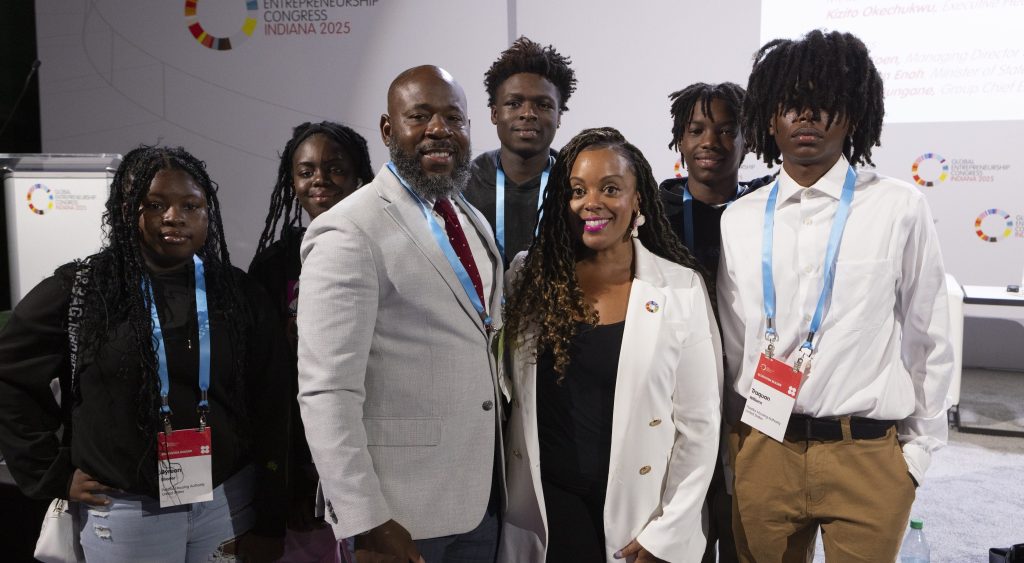 Group of adults standing together indoors at a formal event